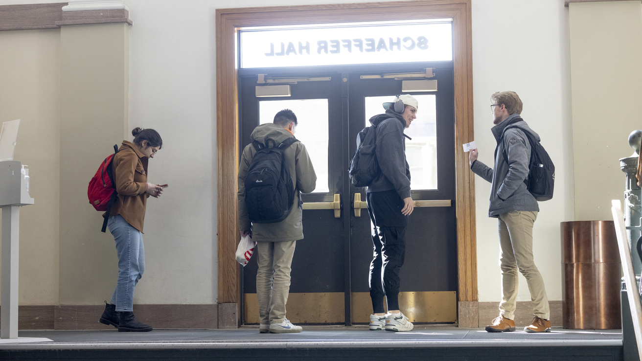 students at the front of Schaeffer Hall door